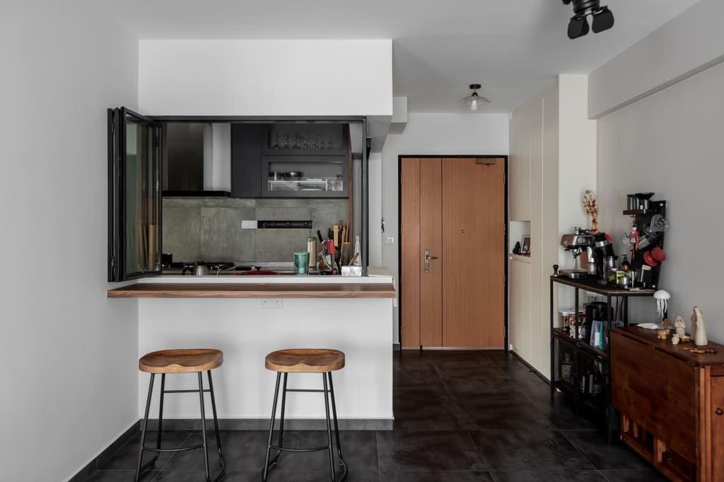 Glass servery window between kitchen and living room at Chai Chee Road by MET Interior, an alternative to a fully open kitchen in an HDB flat